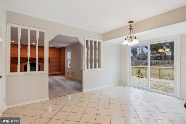 unfurnished dining area featuring light tile patterned floors and a chandelier