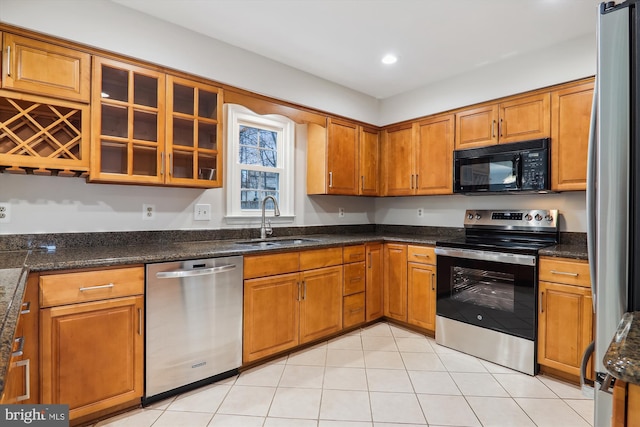 kitchen with sink, stainless steel appliances, and light tile patterned flooring