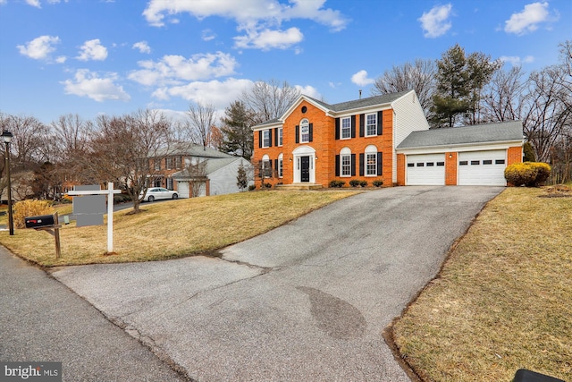 view of front of home with a garage and a front lawn