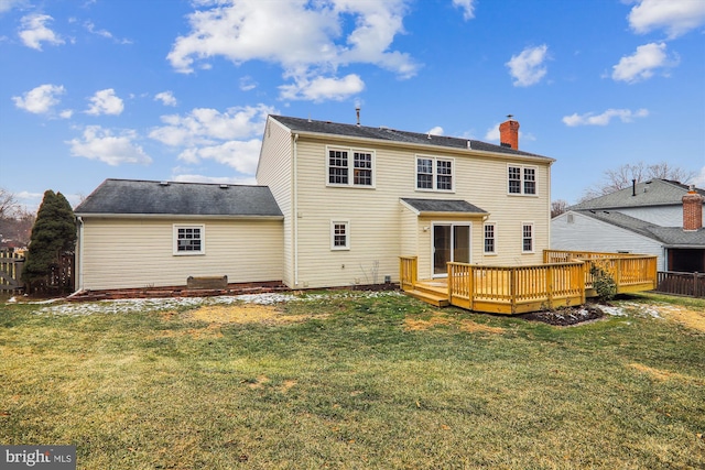 back of property featuring a yard and a deck