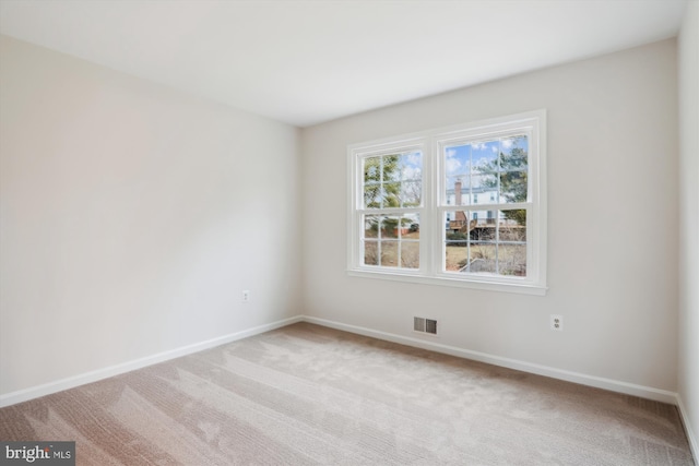 spare room with light carpet