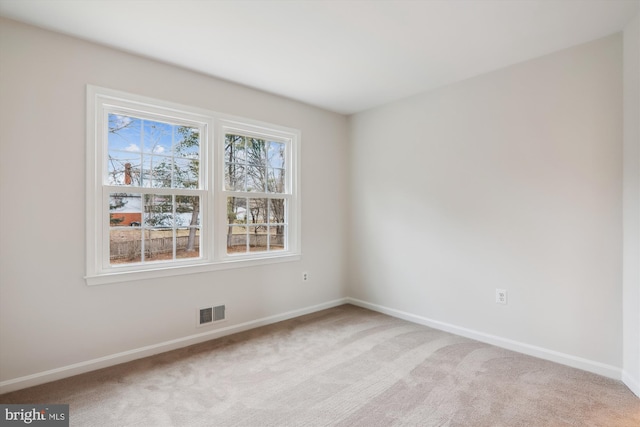 empty room featuring light carpet