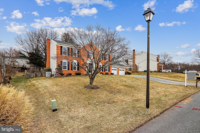 view of front of property featuring a garage and a front lawn