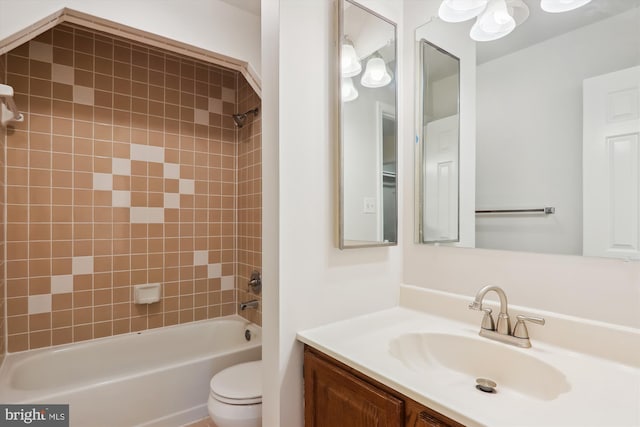 full bathroom with tiled shower / bath combo, vanity, and toilet