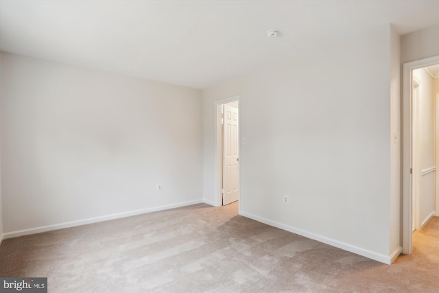 unfurnished bedroom featuring light carpet