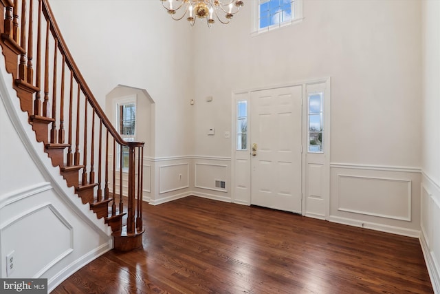 entrance foyer with dark hardwood / wood-style flooring and a chandelier