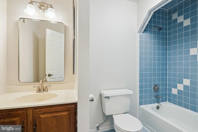 full bathroom featuring tiled shower / bath combo, vanity, and toilet