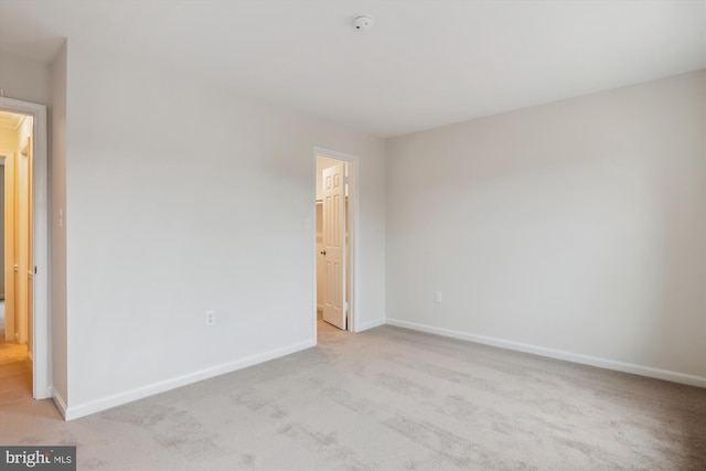 unfurnished bedroom featuring light carpet