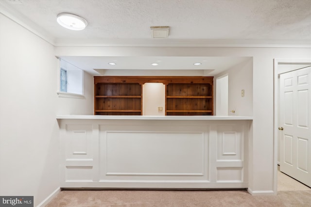 interior space featuring light carpet and a textured ceiling