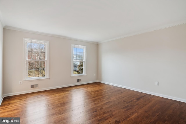 spare room featuring hardwood / wood-style flooring and ornamental molding