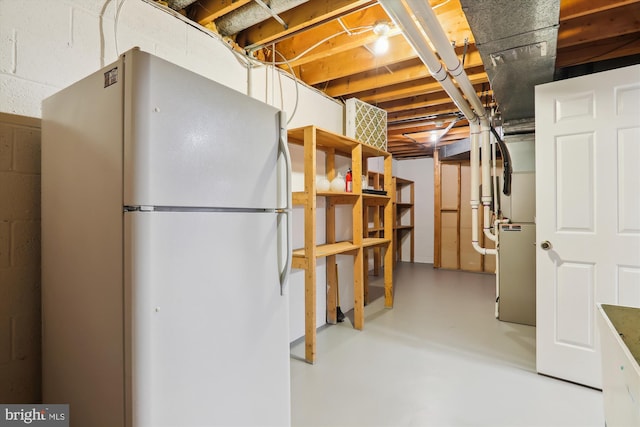 basement featuring white fridge