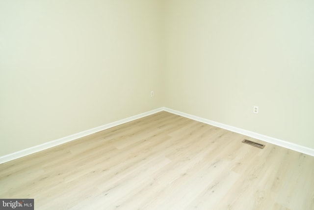 spare room with light hardwood / wood-style floors