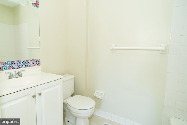 bathroom featuring vanity, toilet, and tile patterned flooring