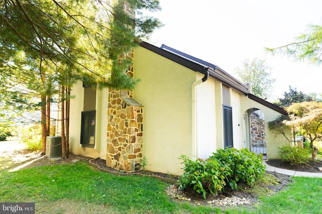 view of side of home with a lawn