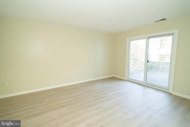 unfurnished room with light hardwood / wood-style flooring