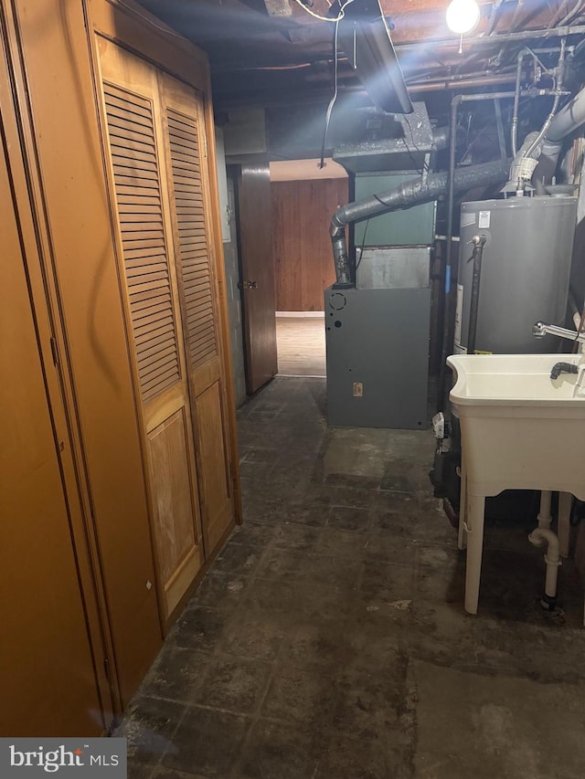 basement featuring heating unit and water heater