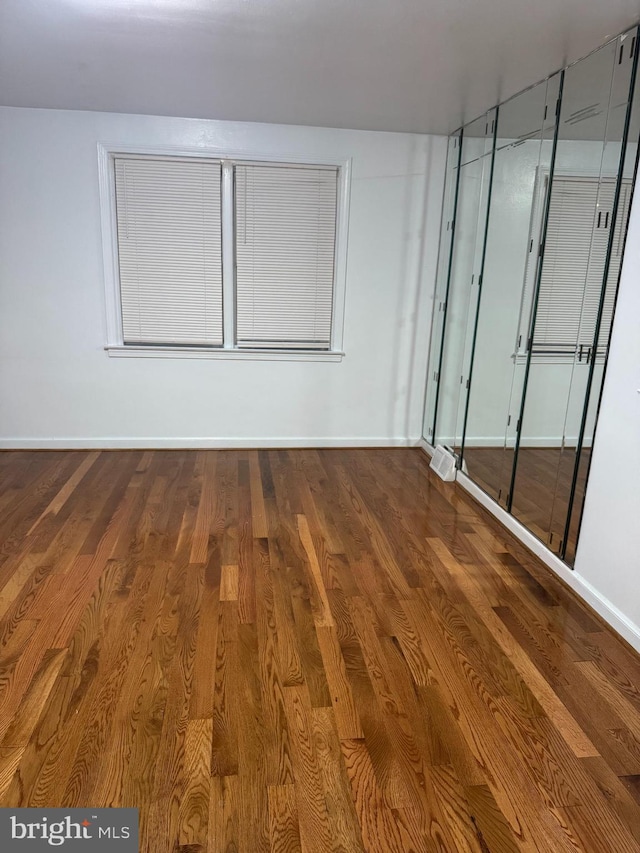 spare room with hardwood / wood-style flooring