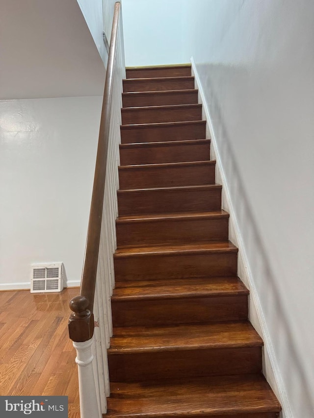 staircase featuring hardwood / wood-style flooring