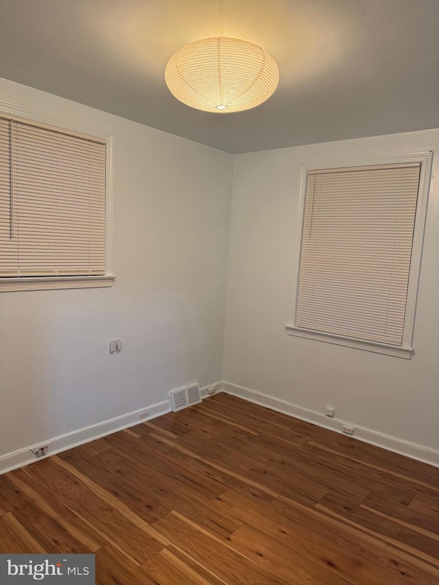 empty room with dark hardwood / wood-style floors