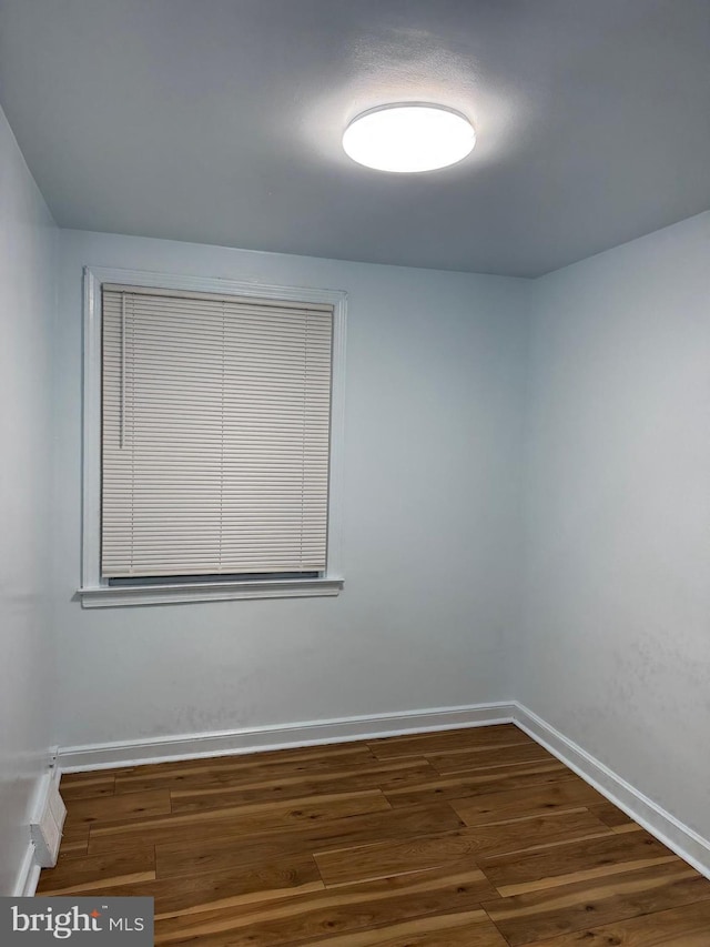 spare room featuring dark hardwood / wood-style flooring