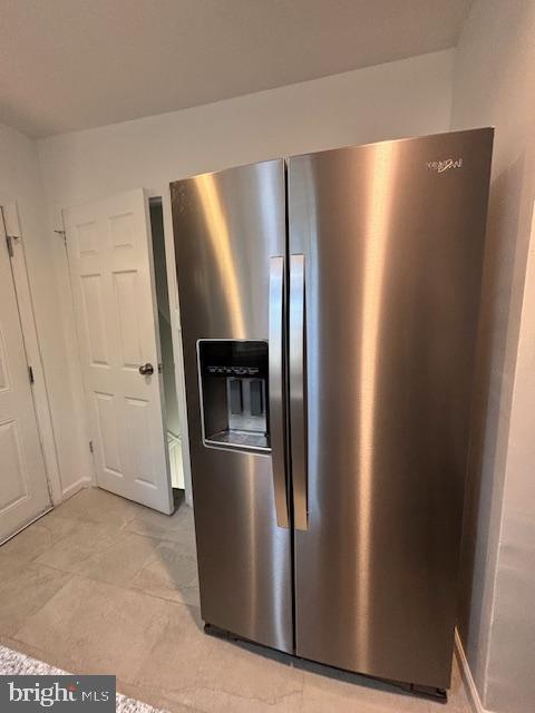 interior space featuring stainless steel fridge with ice dispenser