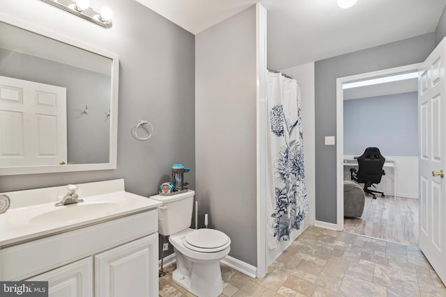 bathroom featuring vanity and toilet