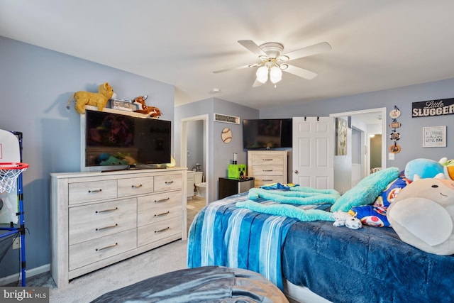 carpeted bedroom with connected bathroom and ceiling fan