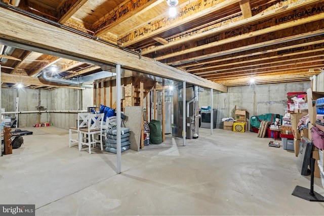 basement featuring heating unit and water heater