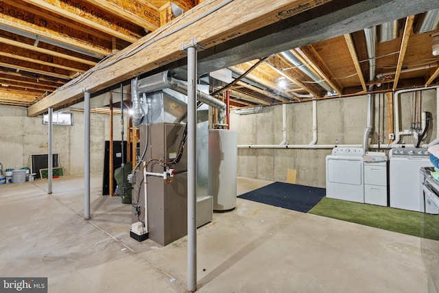 basement with water heater and washer and clothes dryer