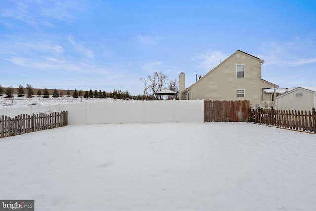 view of yard layered in snow