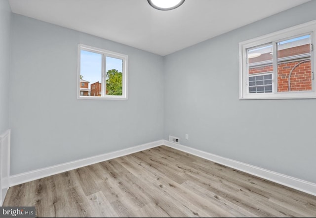 unfurnished room with light hardwood / wood-style floors