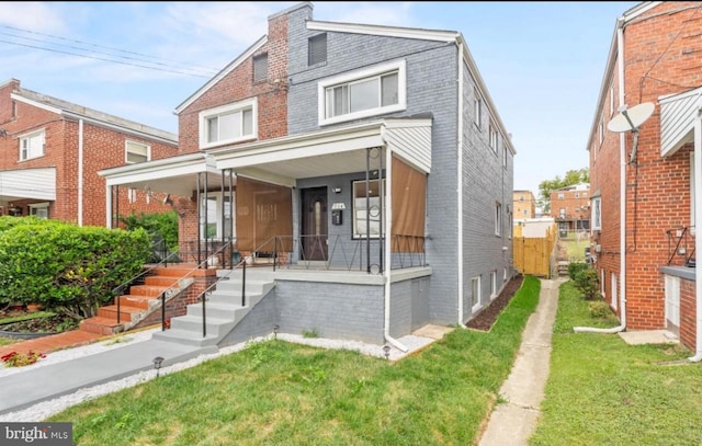 view of front of house with a porch and a front yard