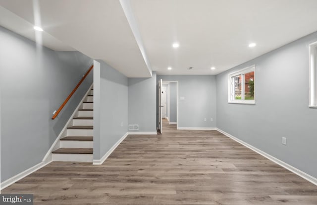 basement with light hardwood / wood-style flooring