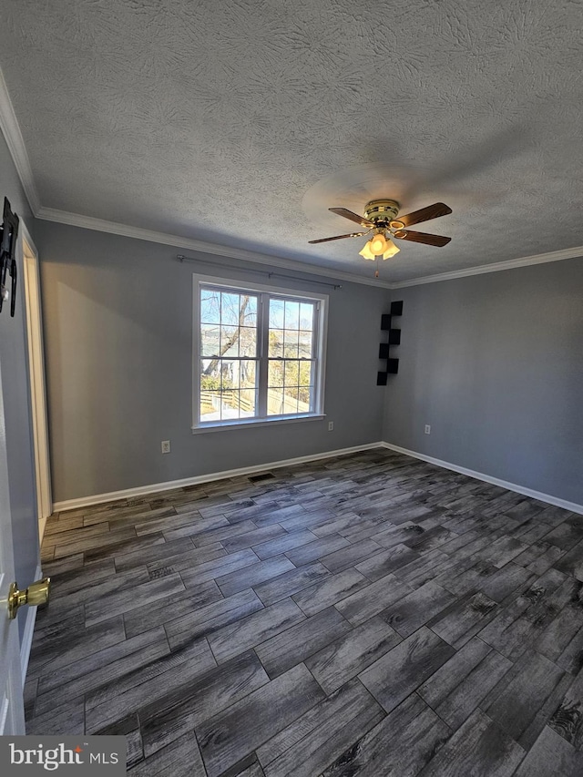 unfurnished room featuring ornamental molding, dark wood finished floors, baseboards, and a ceiling fan