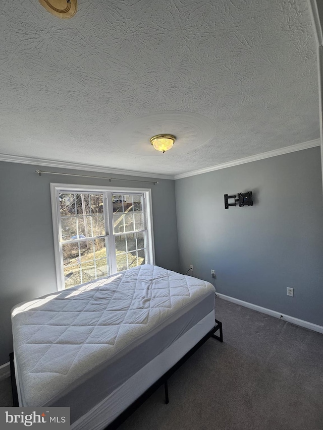 carpeted bedroom with crown molding, a textured ceiling, and baseboards