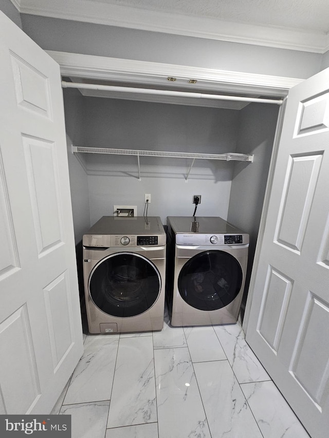 laundry area with laundry area, independent washer and dryer, and marble finish floor