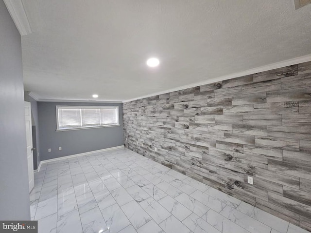 below grade area featuring marble finish floor, crown molding, recessed lighting, a textured ceiling, and baseboards