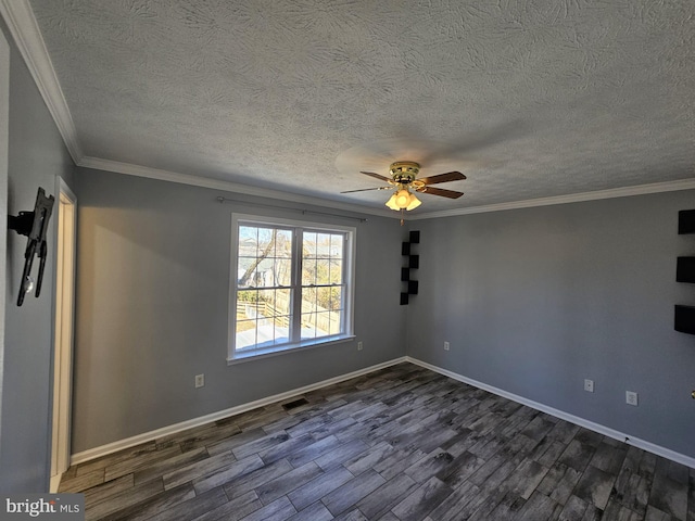 unfurnished room with dark wood finished floors, visible vents, ornamental molding, ceiling fan, and baseboards