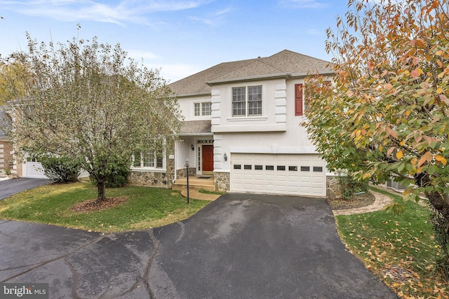 view of front of property with a garage and a front lawn