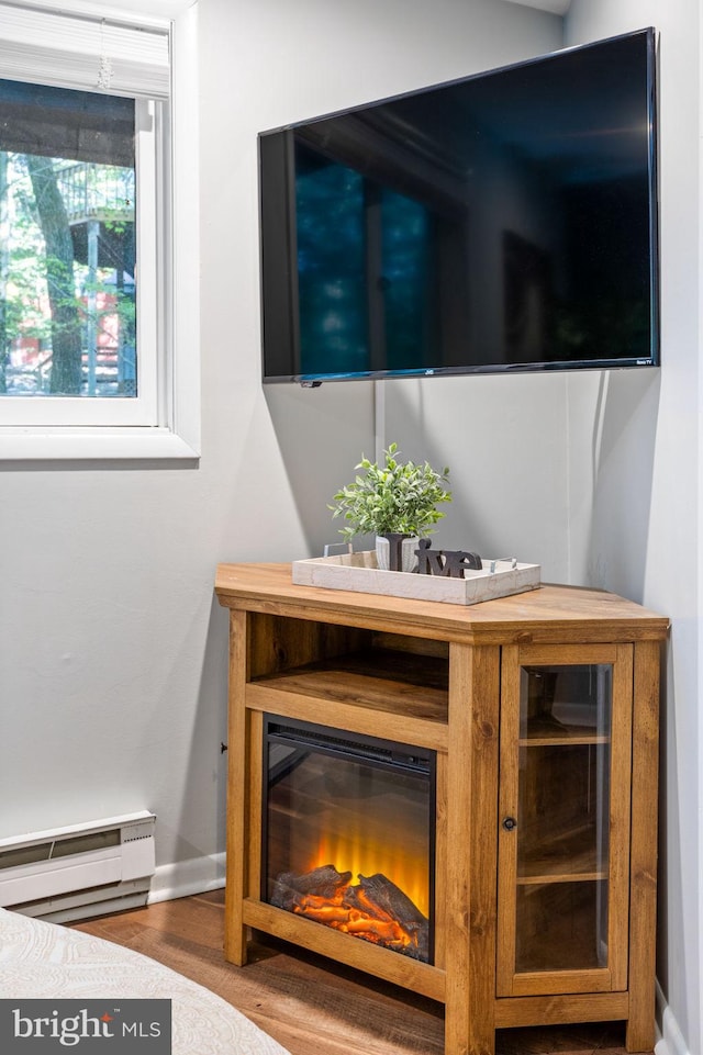 room details featuring hardwood / wood-style flooring and a baseboard heating unit