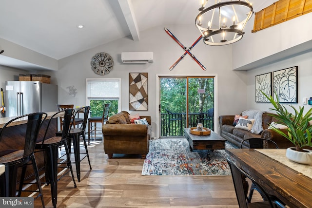 living room featuring beam ceiling, high vaulted ceiling, a wall mounted air conditioner, a chandelier, and light wood-type flooring