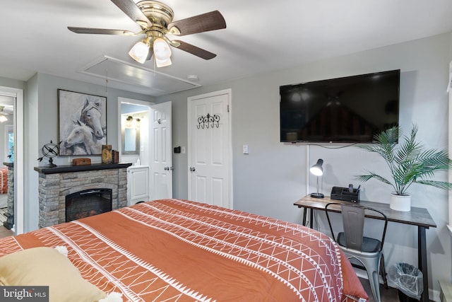 bedroom with ceiling fan and a fireplace