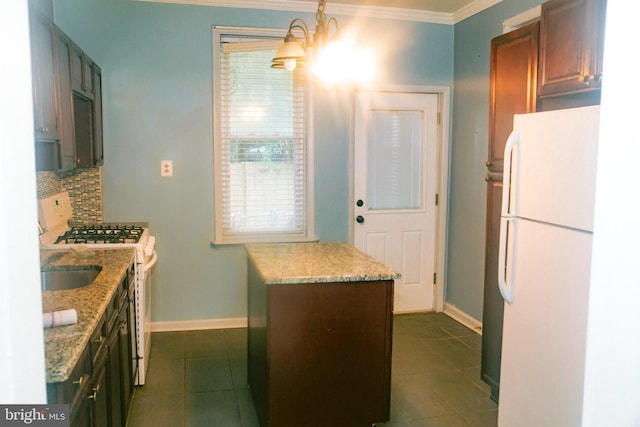 kitchen with crown molding, an inviting chandelier, decorative light fixtures, white appliances, and decorative backsplash