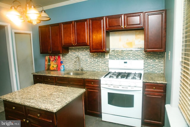 kitchen featuring sink, backsplash, light stone countertops, and white range with gas stovetop