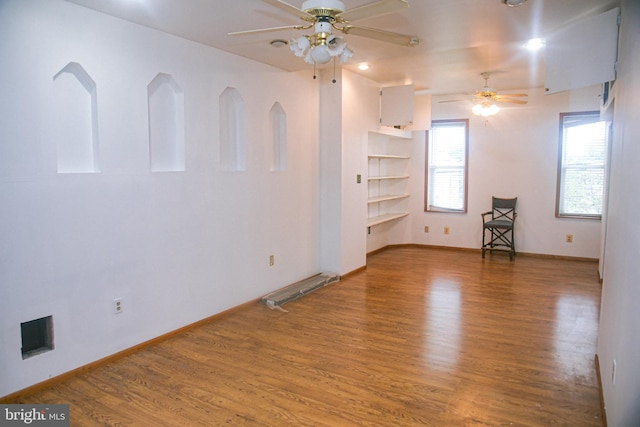 spare room with wood-type flooring and ceiling fan