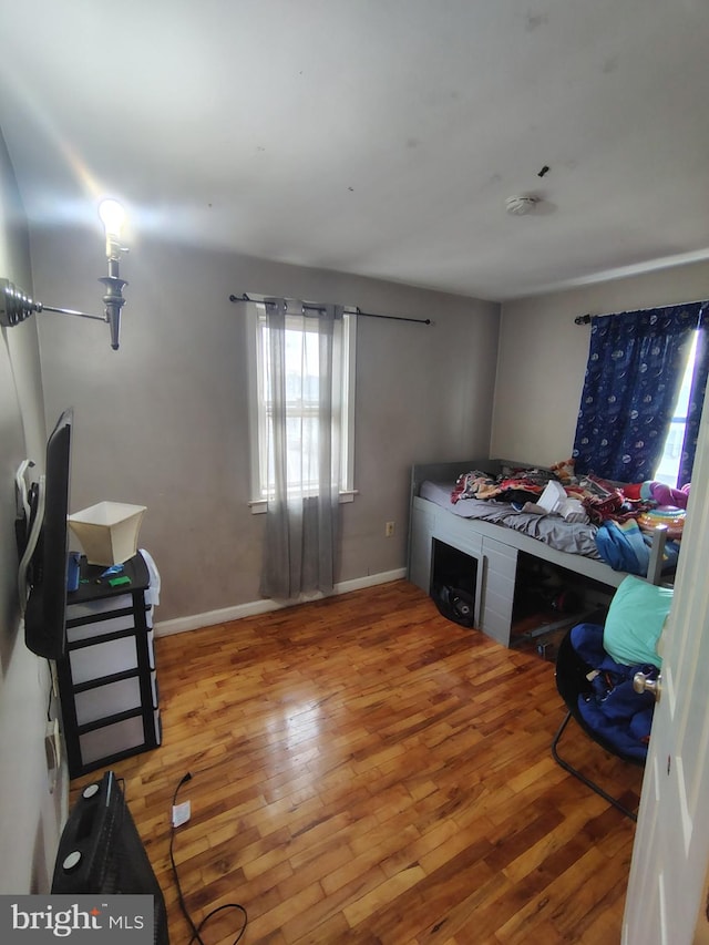 bedroom with hardwood / wood-style floors