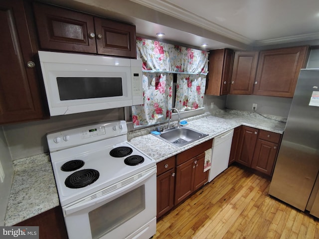 kitchen featuring sink, dark brown cabinets, light hardwood / wood-style flooring, ornamental molding, and white appliances