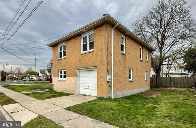 view of home's exterior with a yard and a garage