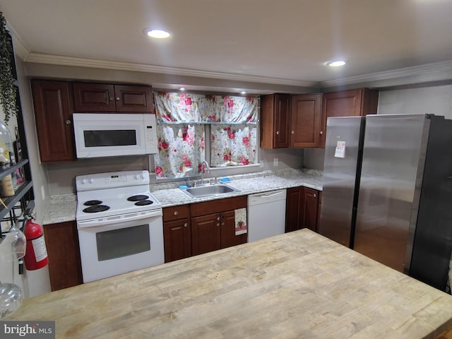 kitchen with sink, dark brown cabinetry, crown molding, light stone countertops, and white appliances