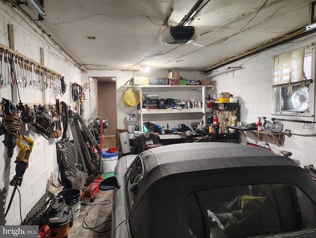 garage with a garage door opener and a workshop area